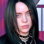 Billie Eilish, a woman with black shoulder-long hair all dressed in black.