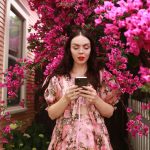 woman on cellphone in pink flowers